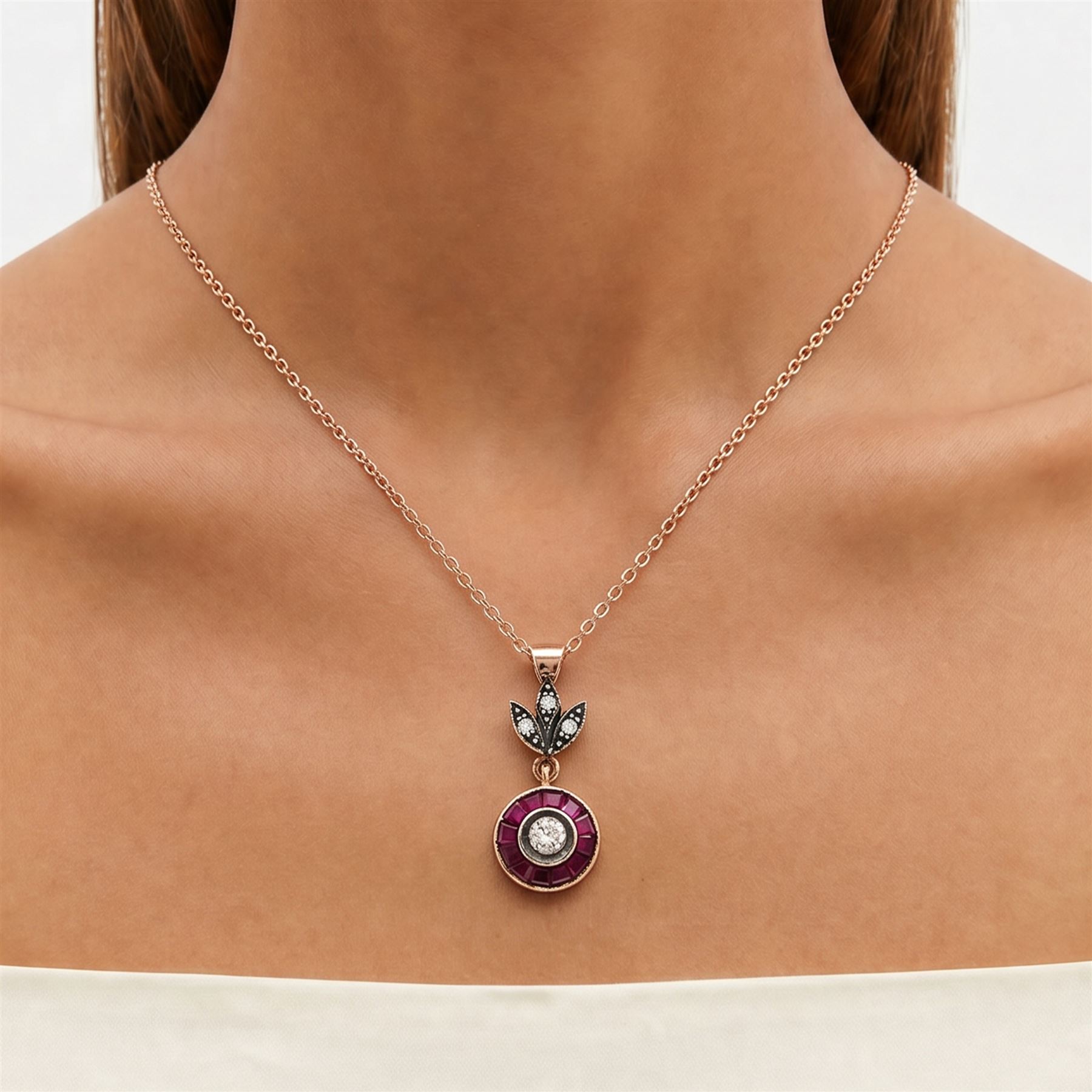 Gold and silver ruby and diamond pendant, single round brilliant cut diamond, surrounded by calibre cut rubies and round brilliant cut diamonds, suspending from a fancy pendant set with further diamonds, on a rose gold plated silver chain necklace, total diamond weight approx 0.30 carat, total ruby weight approx 0.30 carat