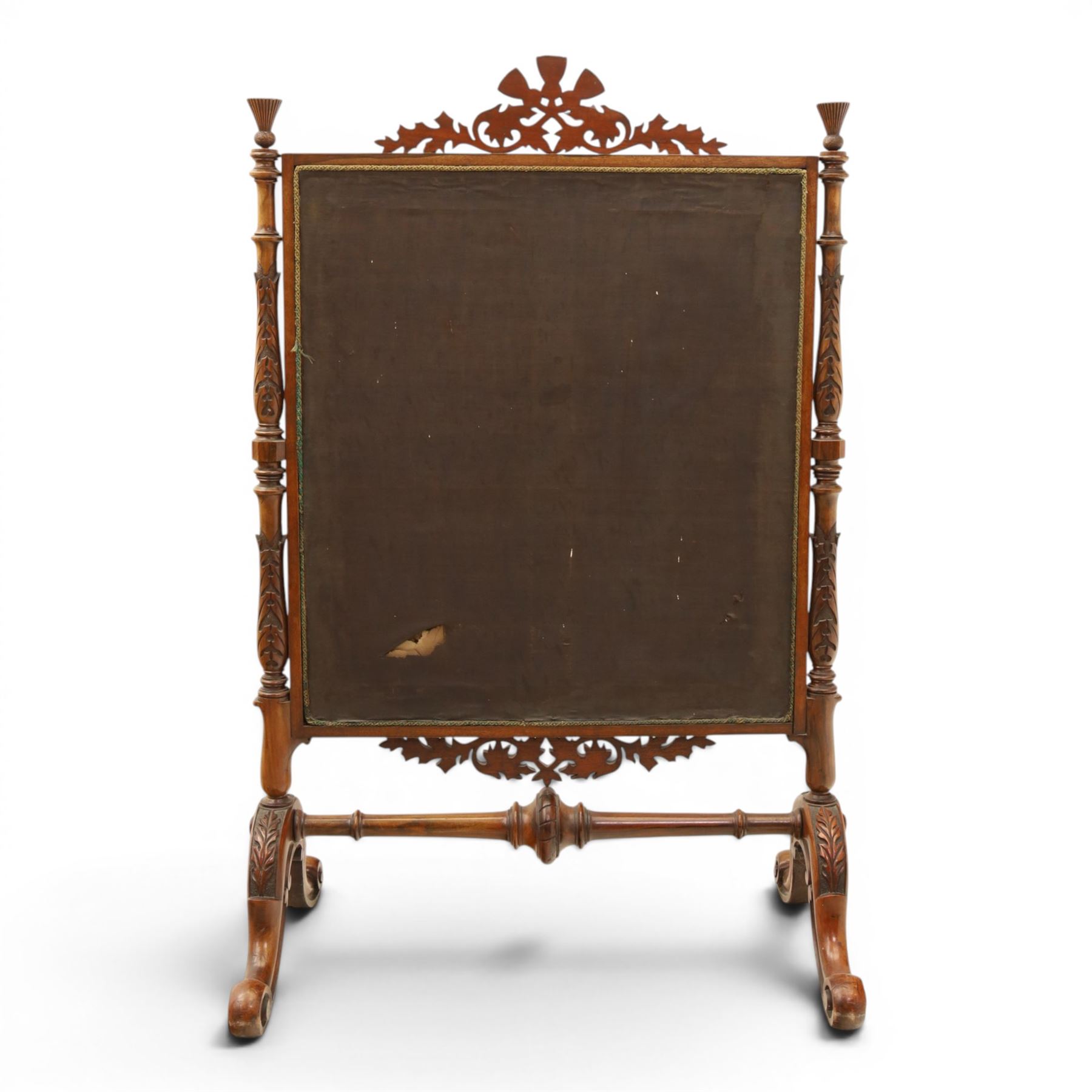 Two Victorian fire screens, comprising mahogany pole screen with glazed floral woolwork panel on turned support and triform base (H 142cm, W 48cm); and a larger carved walnut tapestry fire screen, glazed panel depicting a domestic interior scene, scroll carved cresting, barley twist uprights and turned stretcher base (H 75cm, W 49cm)