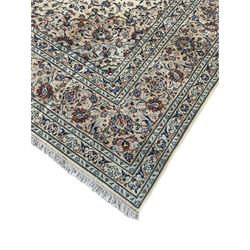 Persian Kashan ivory ground carpet, the field decorated with interlacing foliate branches and stylised plant motifs, scrolling border decorated with repeating palmettes, within floral pattern guard bands