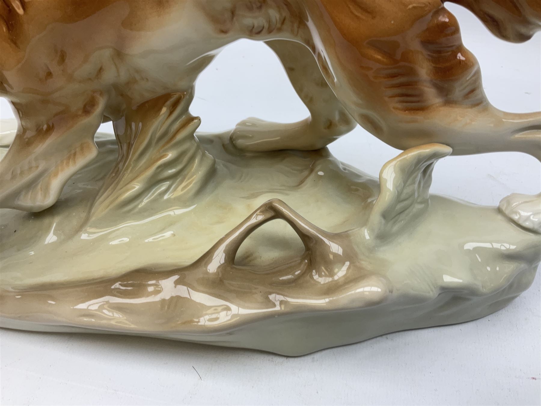 Royal Dux porcelain hunting dog with a bird, printed mark beneath, L36cm