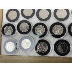 Thirty-seven commemorative fifty pence coins, including 2011 wrestling, other Olympics, Beatrix Potter etc, housed in capsules