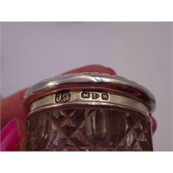 Seven early 20th century and later glass dressing table jars with silver covers, to including an amber glass example and several cut glass examples, all of varying size and design, hallmarked, tallest H7.5cm