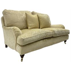 Multi-York - Howard shape two-seat sofa, upholstered in scrolling floral pattern loose covers, rolled arms, on turned front feet with brass cups and castors