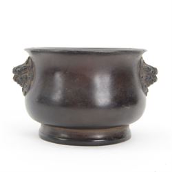 Chinese bronze censer, of circular bellied form with temple lion mask handles, upon a circular foot, with apocryphal six character Xuande mark within a border of two dragons chasing a pearl, H7.5cm D10/5cm
