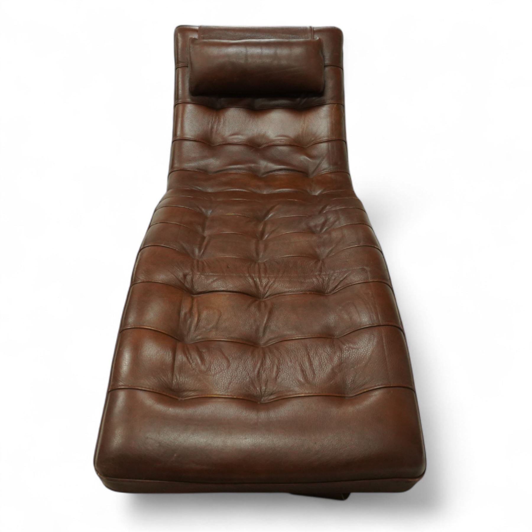 Barker & Stonehouse -stylish contemporary leather chaise longue, upholstered in brown tufted leather panels, sinuous wave-shaped frame with headrest cushion, raised on angled chrome effect legs