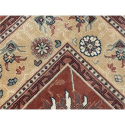 Late 20th century Royal Keshan 'Agra' hand-knotted wool rug, terracotta ground with central floral medallion and scrolling vines, enclosed by a cream border with repeating floral motifs