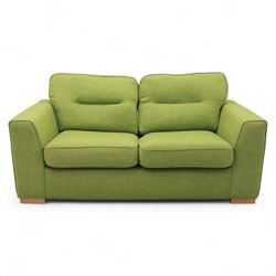 Contemporary lime green upholstered sofa bed, with rectangular arms and two seat cushions, the back with two stitched backrest cushions, on low block feet