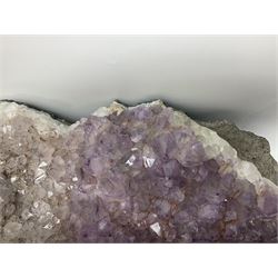 Amethyst crystal geode cluster, with well-defined crystals of various sizes, H13cm, L46cm