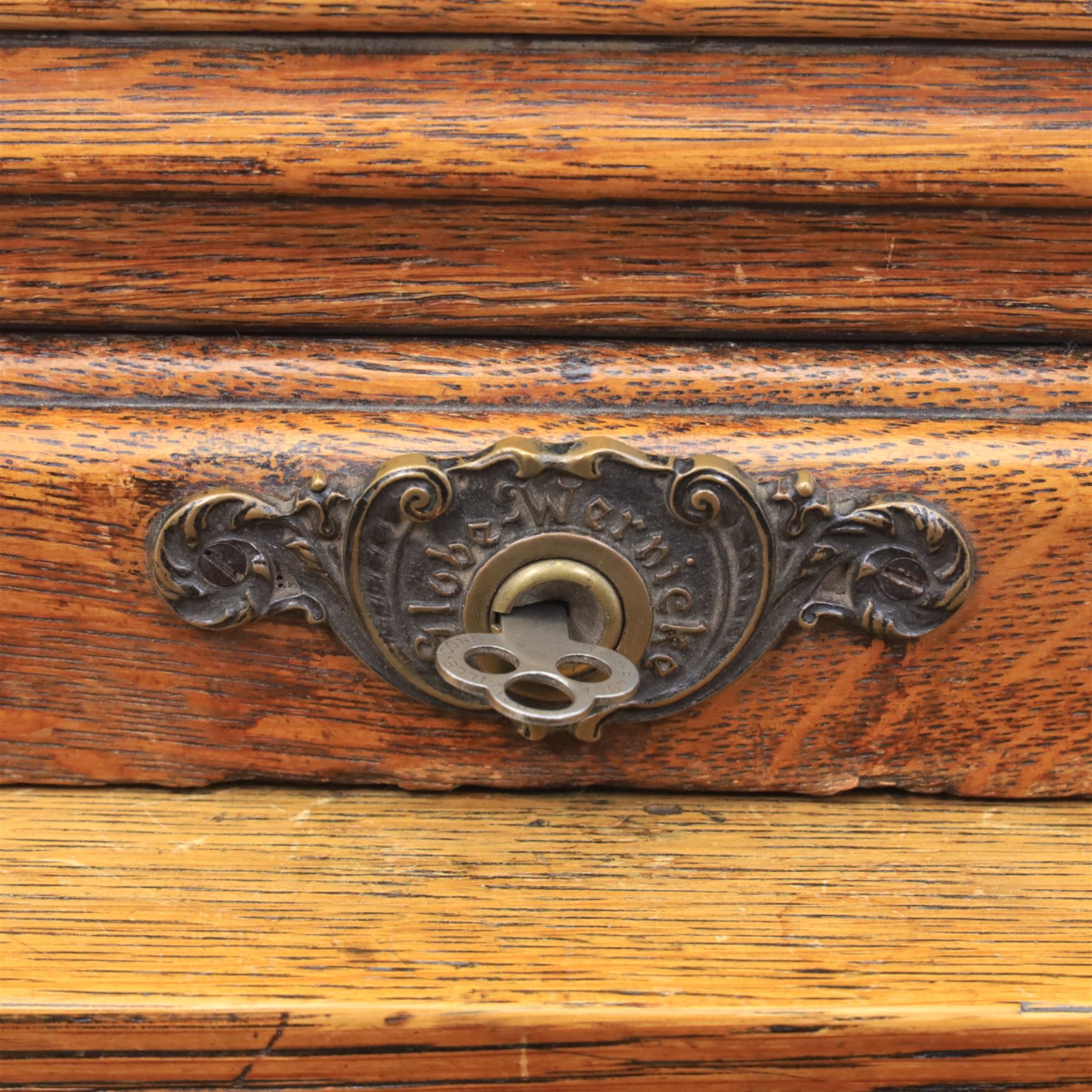 Globe Wernicke - Oak roll top desk, fitted with nine drawers, oak tambour roll top revealing a fitted interior, with single frieze drawer, flanked by four drawers to each pedestal, on a plinth base