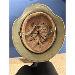 German Third Reich Waffen-SS M35 double decal helmet, the left inner brim stamped SF64, the back inner brim stamped 3866, with leather eight tongue liner and chinstrap