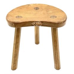 'Mouseman' oak three legged stool with dished kidney shaped seat, tapered octagonal supports, with carved mouse signature, by Robert Thompson of Kilburn 