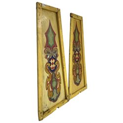 Two early 20th century fairground 'Chair-O-Plane' panels, wooden framed with sheet metal panels, painted in yellow with scrolled cartouche decoration in red, gold and green