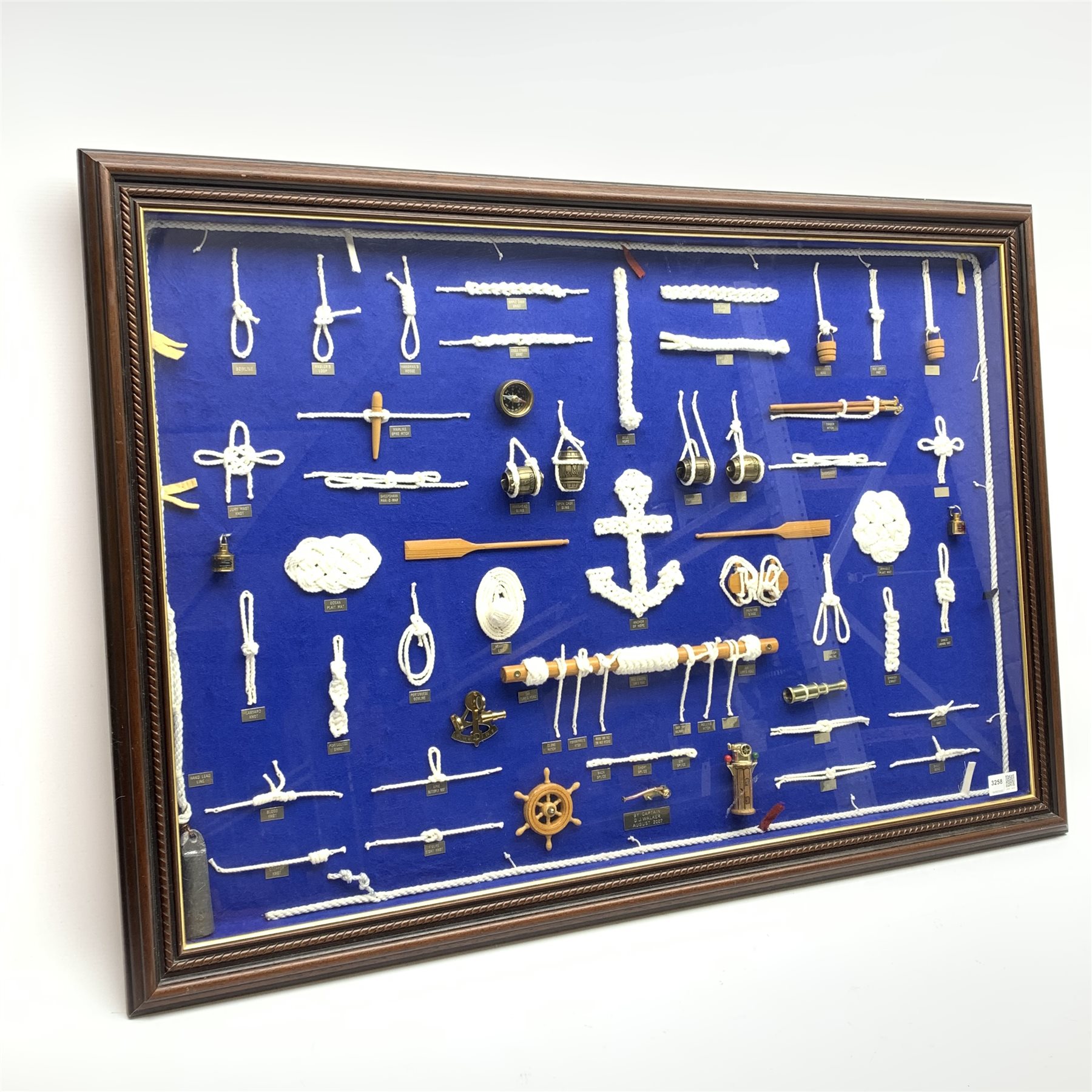  Large framed knot board, including miniature Binnacle, ships wheel and sextant, by Captain D.J.Walker August 2007, W90cm, H60cm,  Provenance:  Captain Walker was captain of the North Sea Ferry Norland which was later requisitioned by the MOD to be used as a Troopship to be sent to the Falkland Islands  