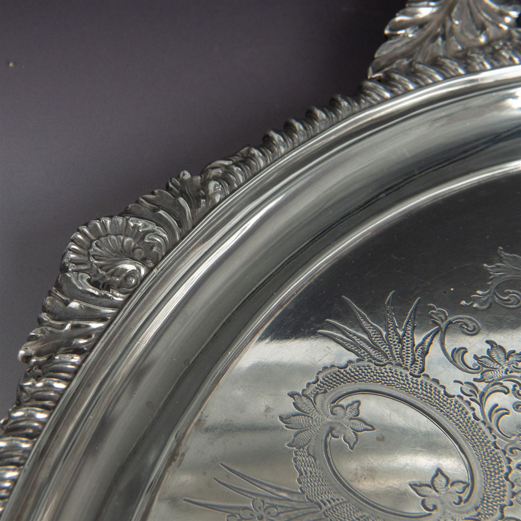 Victorian silver twin handled tray, of oval form, engraved with floral and foliate swags with vacant cartouche to centre, with oblique gadrooned rim, palmette details and foliate decoration to handles, hallmarked Atkin Brothers, Sheffield 1901, handle to handle W70cm