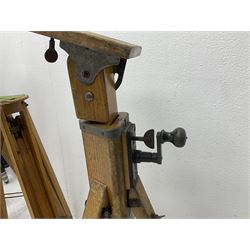 Three wooden adjustable tripods for plate cameras, together with a Linhof of Munchen metal tripod in a canvas case 