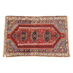 Northwestern Persian village rug, madder red field, with serrated central panel enclosing ...