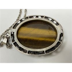 Gold Chinese pendant, silver tiger's eye pendant necklace and a similar silver moss agate pendant