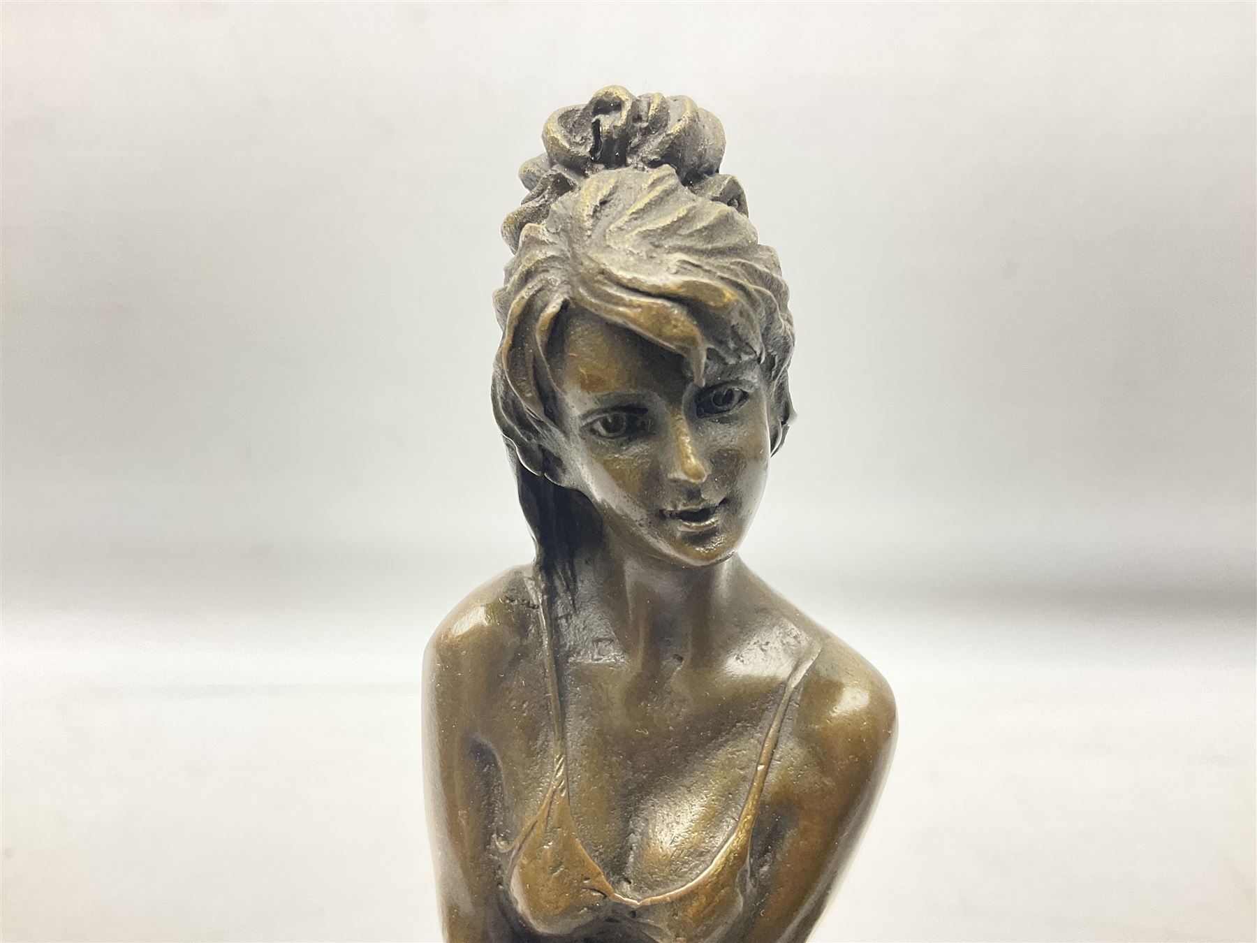 Art Deco style bronze modelled as a female figure seating crossed legged upon a chair, after Pierre Collinet, H28cm