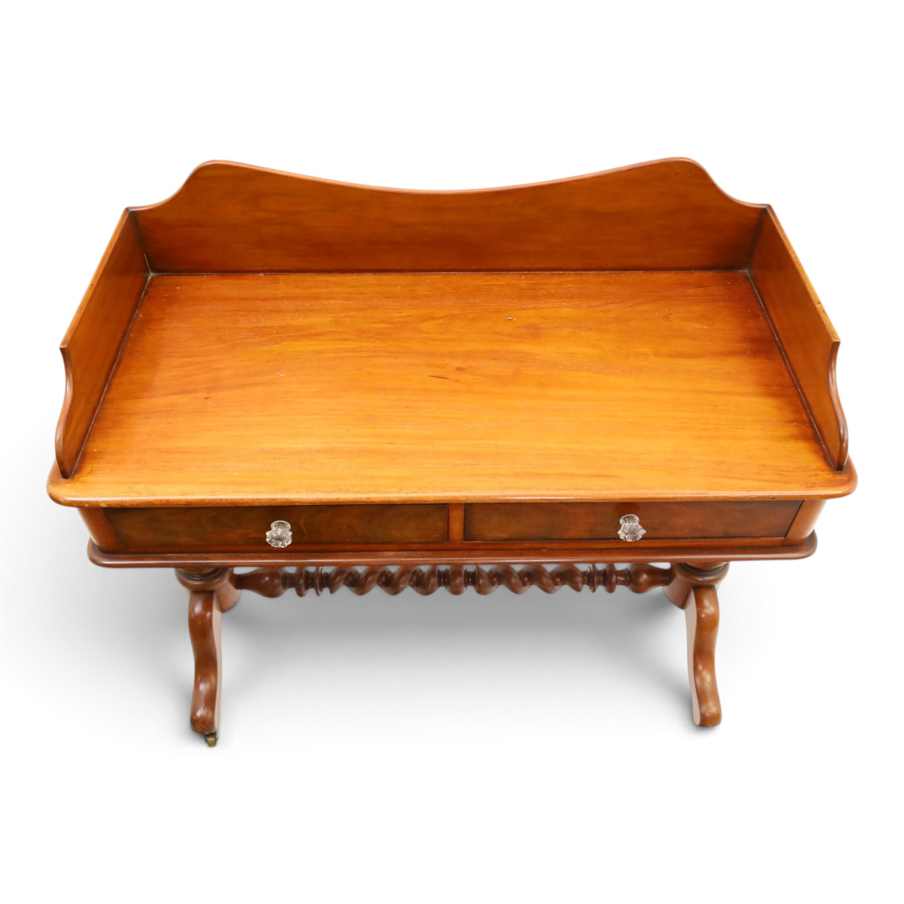 Victorian mahogany washstand with raised three-quarter back, fitted with two frieze drawers with glass handles, raised on spiral turned supports with splayed supports and castors united by barley-twist stretcher