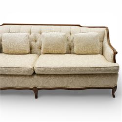 Mahogany framed three seat sofa in the Louis XV style, the shaped buttoned back above loose seat cushions and scrolling arms, raised on cabriole legs with shaped apron