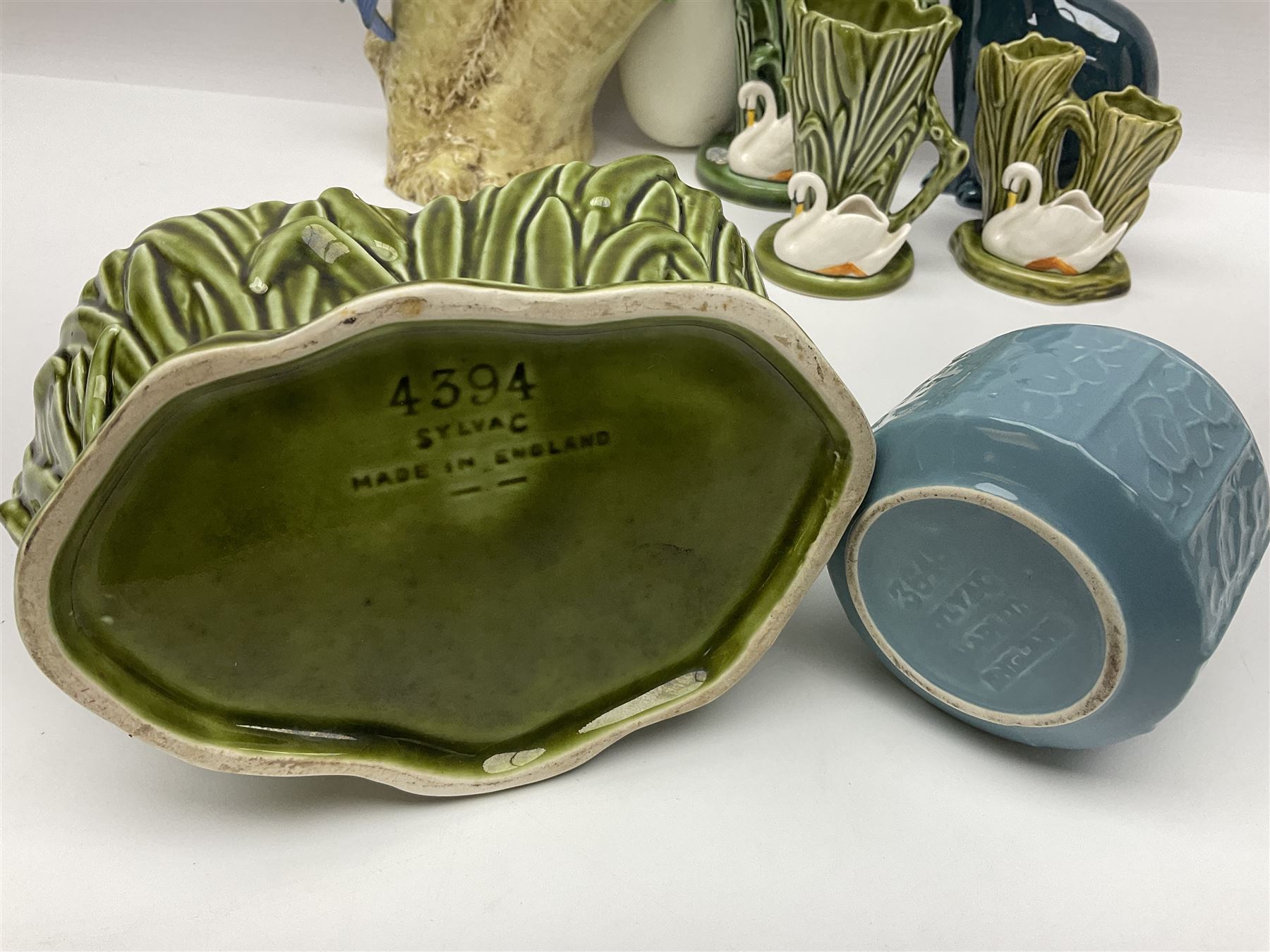 Sylvac budgieregar wall pocket, together with other Sylvac cermics including swan vases, blue tit vase and a frog figure etc, all with printed or impressed marks beneath, and a Poole Pottery cat figure, with printed mark beneath, wall pocket H22cm