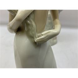 Lladro 'Walk With the Dog' figure no. 4893, together with Lladro swan figure, Porceval figure of a gentleman with a bird perched upon his hand and a further of a lady with flowers beside a basket, all with marks beneath, tallest H40cm