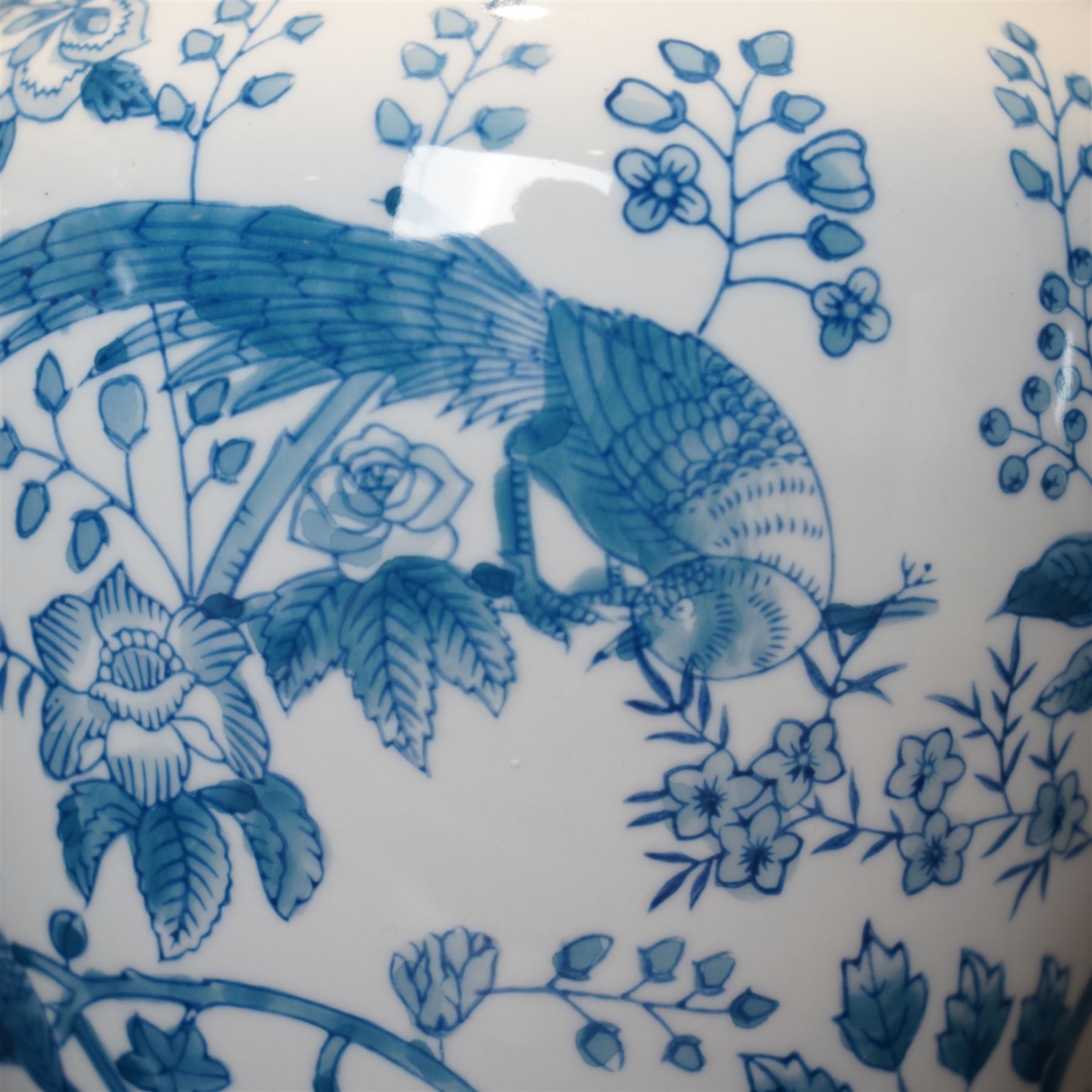 Pair of table lamps of baluster form, decorated with exotic birds up fruiting trees, on hardwood pedestals, H55cm including shades