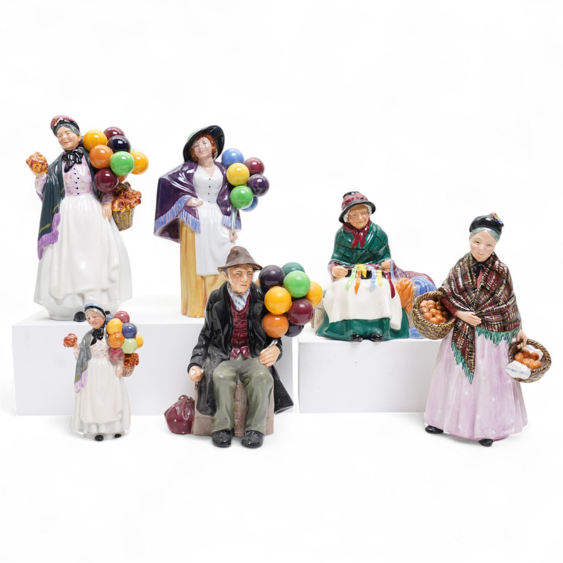 Six Royal Doulton figures, including Balloon Lady HN2935, The Orange Lady HN1759, Silks and Ribbons HN2017 and The Balloon Man HN1954 