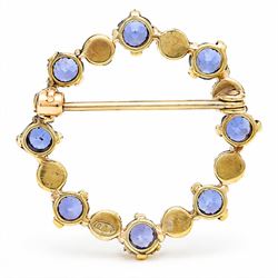 Early 20th century 15ct gold sapphire and pearl circular brooch, set with alternate round cut sapphires and split pearls, stamped 15