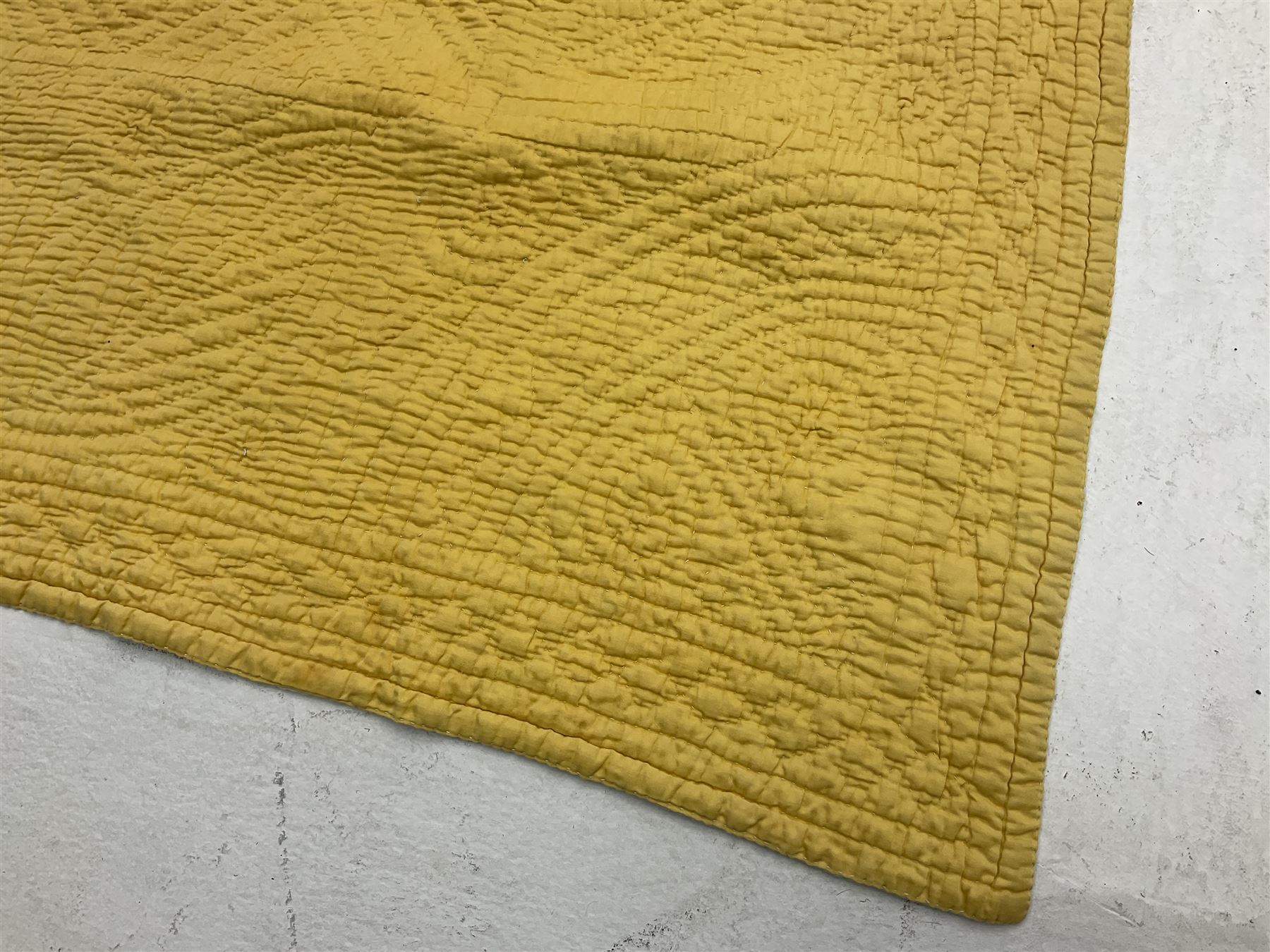 Early 20th century Welsh whole cloth sky blue quilt, in traditional quilting patterns, supported on yellow coloured backing, 174cm x 204cm