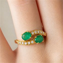 18ct gold emerald and diamond crossover ring, set with five round brilliant cut diamonds and two oval cut emerald finials, Sheffield 1989, total emerald weight approx 0.40 carat