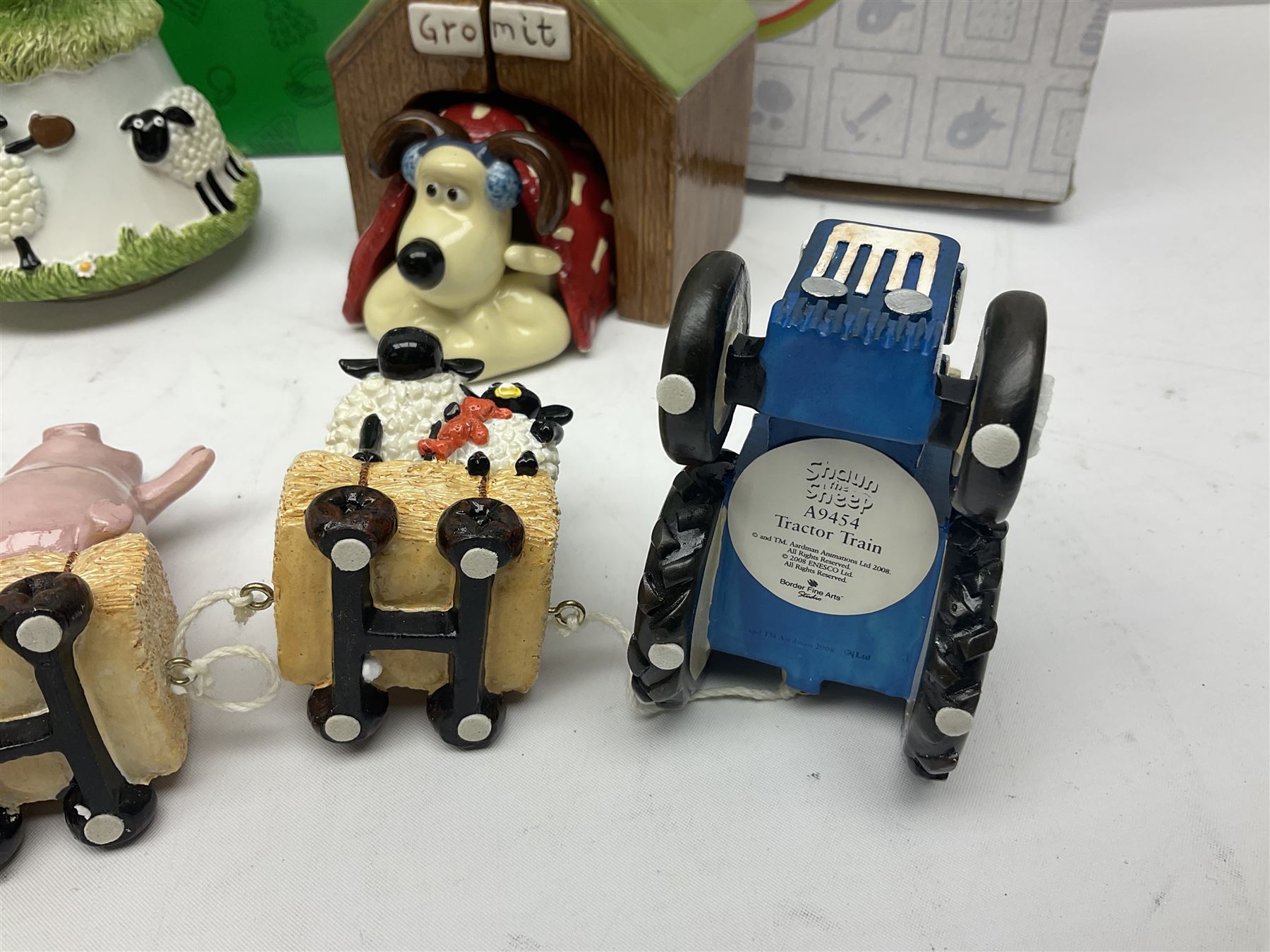 Border Fine Arts Shaun The Sheep Tractor Train and musical figure, together with a Wallace and Gromit photograph frame and a Gromit cruet sett, three in original boxes  