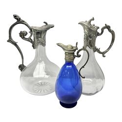  Silver plate mounted blue glass claret jug of ovid form, with C scroll handle, together with two other silver plate mounted claret jug