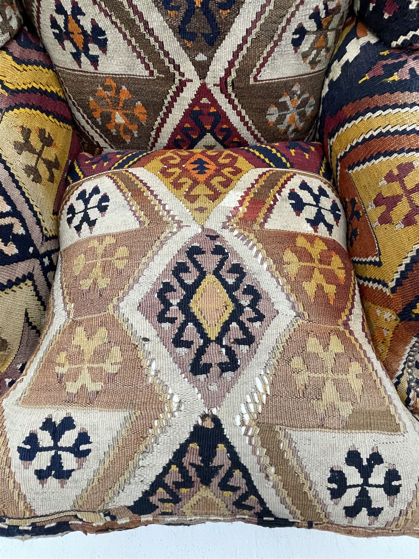 Late 20th century beech framed wingback armchair, sprung seat and back upholstered in kilim cover, acanthus carved cabriole supports with ball and claw feet
