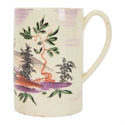 18th century Leeds creamware mug, circa 1770, of cylindrical form with curved strap handle, painted in purple, red and green with a peasant toasting with a glass of ale within a bucolic setting, H12.5cm