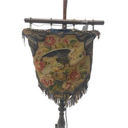 Victorian rosewood pole screen converted to standard lamp, turned column on a triform platform base with compressed bun feet, the beadwork and needlework tapestry depicting a bird amongst foliate