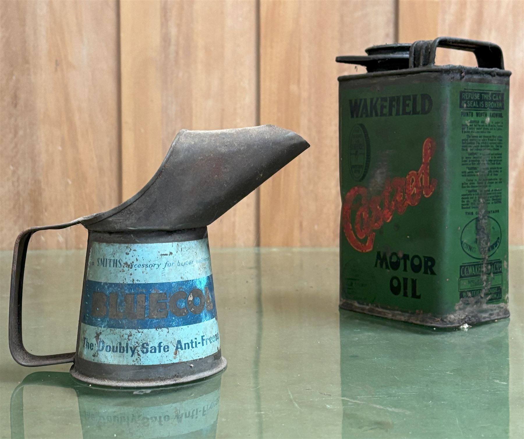 Early Wakefield Castrol motor oil tin (H20cm) together with a Bluecol 1/2 pint pourer (H13cm) (2)  - COLLECTION BY APPOINTMENT FROM: The White House, Thirsk Road, Easingwold, York, YO61 3NF - CALL 01723 507111 TO ARRANGE