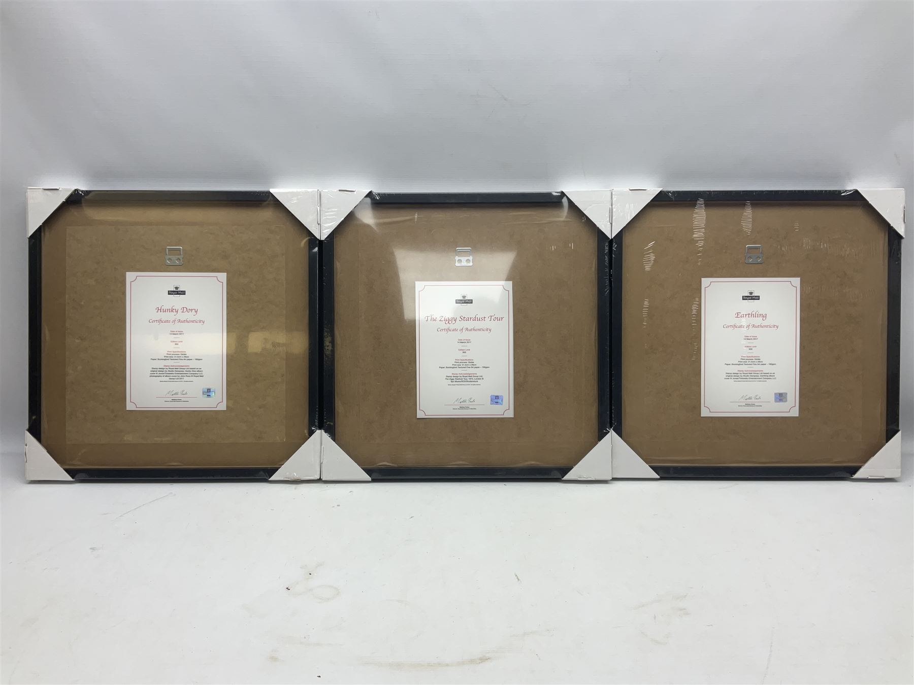 Set of three Royal Mail David Bowie limited edition album stamp prints, comprising  Ziggy Stardust Tour, Hunky Dory and Earthling, all framed and in original packaging, H43cm W43cm