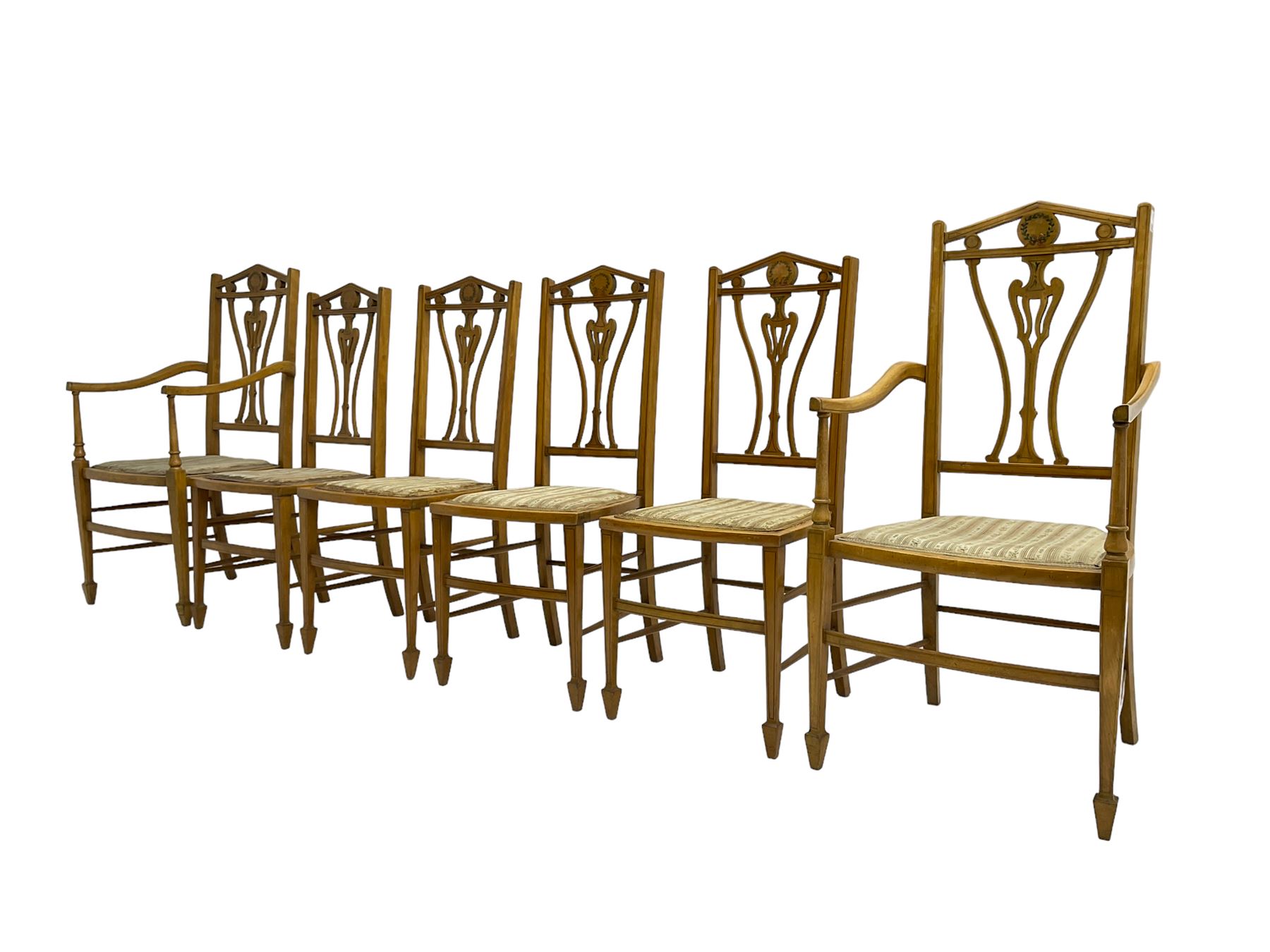 Set six (4+2) Edwardian satinwood dining chairs, triangular cresting rail painted with laurel wreath, shaped and pierced splat flanked by two shaped upright rails, with boxwood stringing, upholstered seats, on square tapering front supports with spade feet