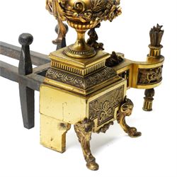 Pair of gilt metal fire dogs, formed as an urn with classical decoration, including putti and floral swags, raised on a square stepped base, the feet formed as rams heads and hoofs, H45cm x W28cm