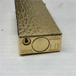 Dunhill gold plated lighter with textured bark effect decoration, in fitted case