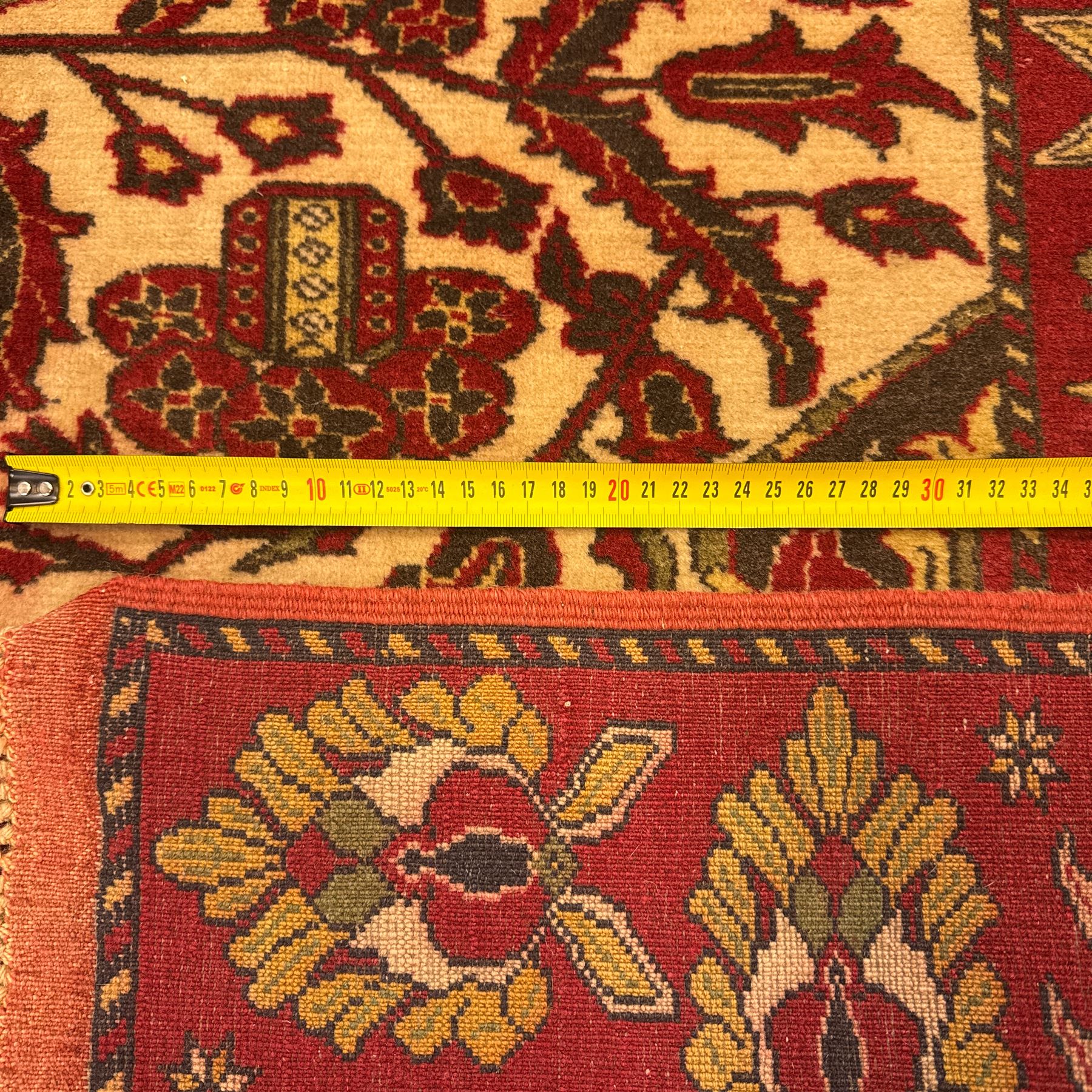 Persian Kerman hand-knotted rug, ivory and crimson ground, central medallion surrounded  by a floral foliate pattern, main border with repeating design of floral cartouches and palmettes, and narrow vine work guard border  