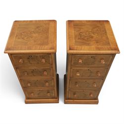Traditional walnut inlaid pair of tall bedside chests, figured top with inlaid banding, four graduating drawers with wooden turned knobs, raised on a plinth  