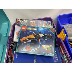 Lego - large quantity of part-built models and loose component parts including Lego Technic and Lego System, space and road vehicles, ships and boats, helicopter etc; together with two set boxes and folder  containing large quantity of instruction booklets; stored in two very large plastic boxes