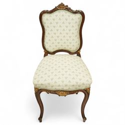 Louis XV design salon suite comprising a pair of walnut and parcel-gilt fauteuil armchairs together with a side chair, the cresting rail surmounted with a carved giltwood floral shell motif with extending foliage, the cartouche shaped backs and sprung seats upholstered in pale blue patterned fabric, over a shaped apron with scallop decoration and foliage carved knees, raised on cabriole supports