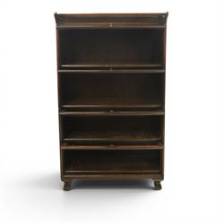 Harris Lebus - oak barrister stacking bookcase, four tier design with glazed fronts with brass knobs, raised on claw and ball feet