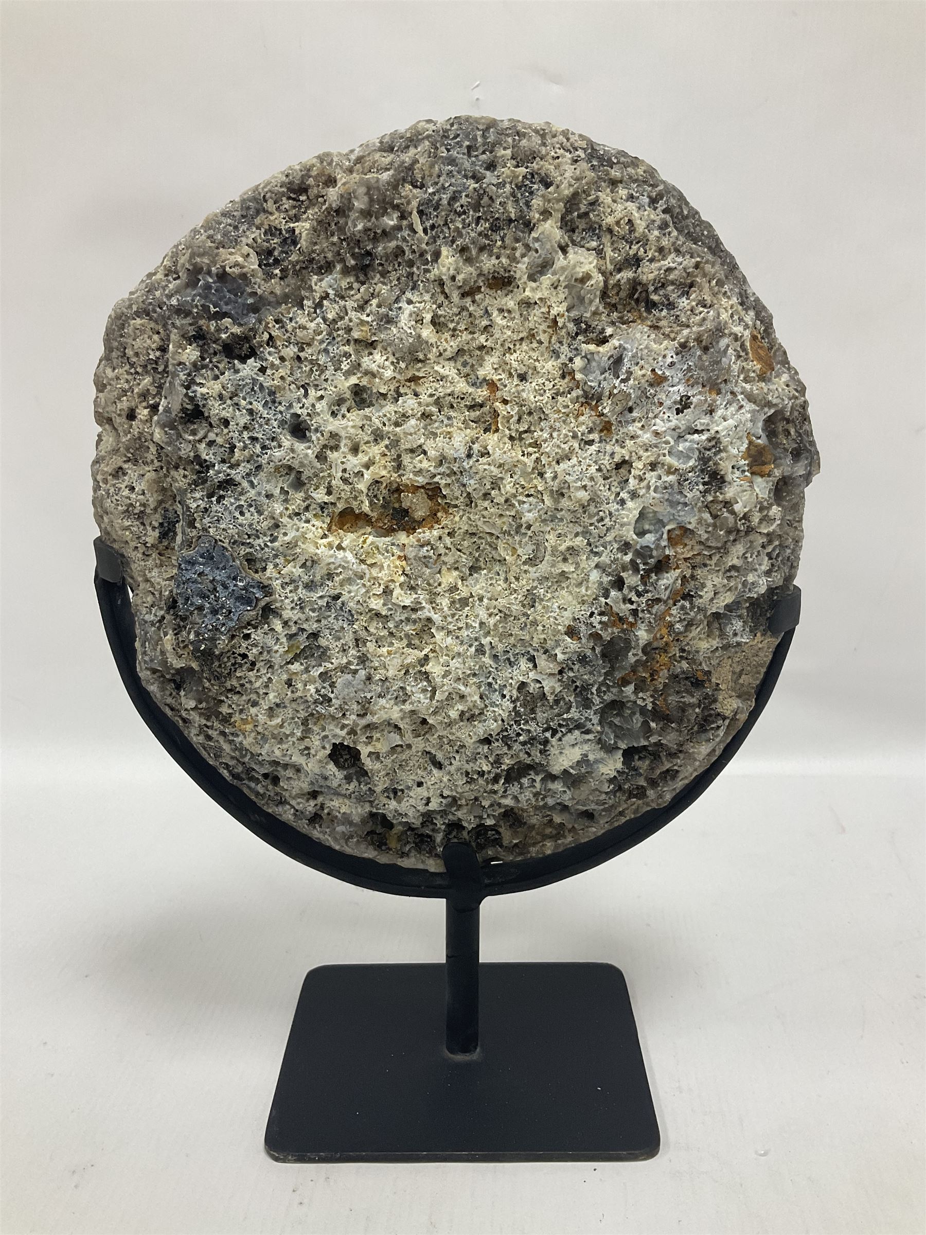 Large agate geode with quartz crystals to the centre, upon a metal stand, H35cm 