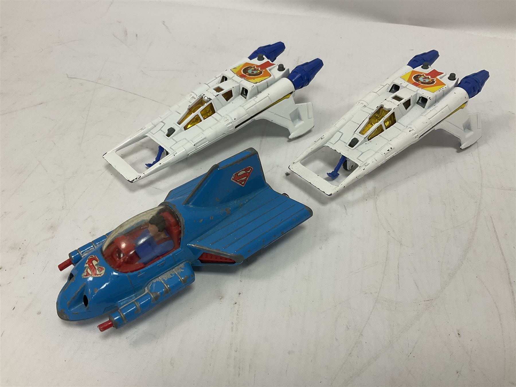 Corgi - seven unboxed and playworn TV/Film related die-cast models including Chitty Chitty Bang Bang with all four figures, Batmobile with both figures, Lady Penelope's FAB 1 with both figures, Superman Supermobile, two Buck Rogers Starfighters and The Saint's Volvo P.1800 (7)