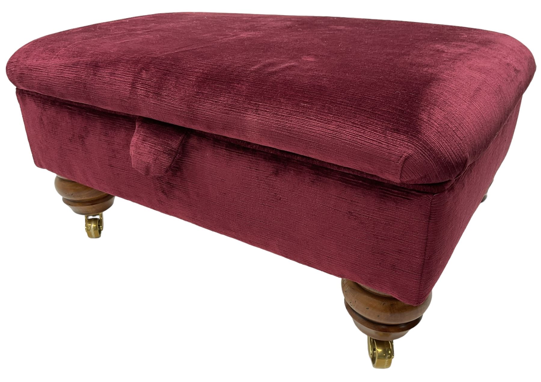 Duresta - traditional shape armchair upholstered in burgundy red velvet, on square tapering front supports (W88cm, H85cm, D103cm); together with a matching rectangular footstool with hinged seat, on turned feet with brass castors (73cm x 54cm, H38cm)
