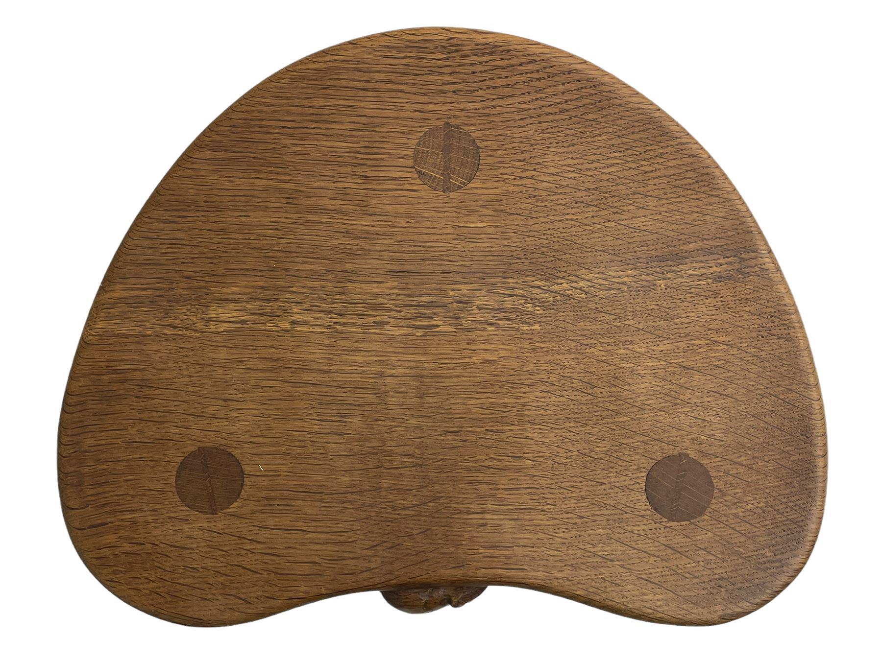 'Mouseman' oak three-legged stool, kidney shaped dished seat carved with mouse signature to edge, by Robert Thomas of Kilburn